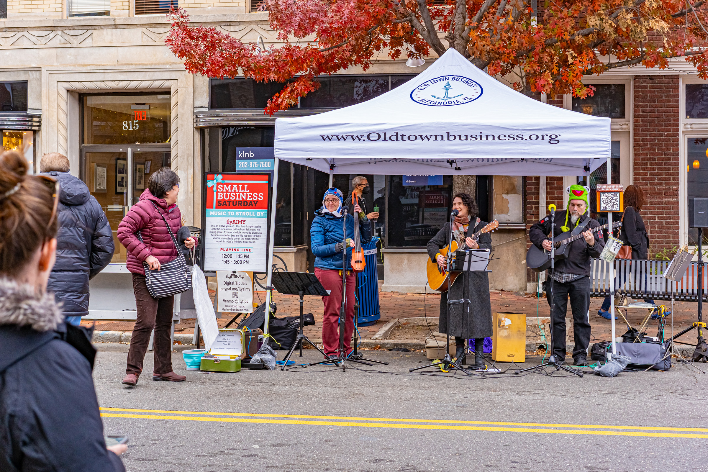Band performs under an Old Town Business tent for Small Business Saturday.